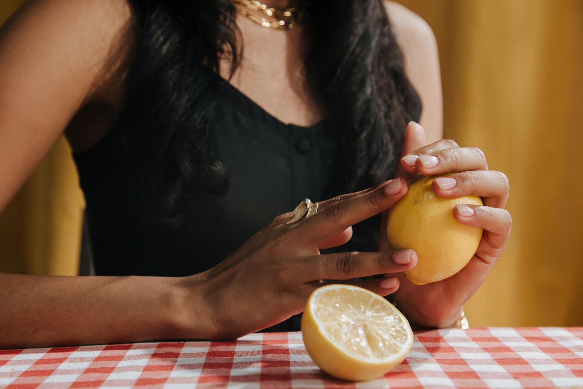 Woman holding silicone vibrators in contemplative pose