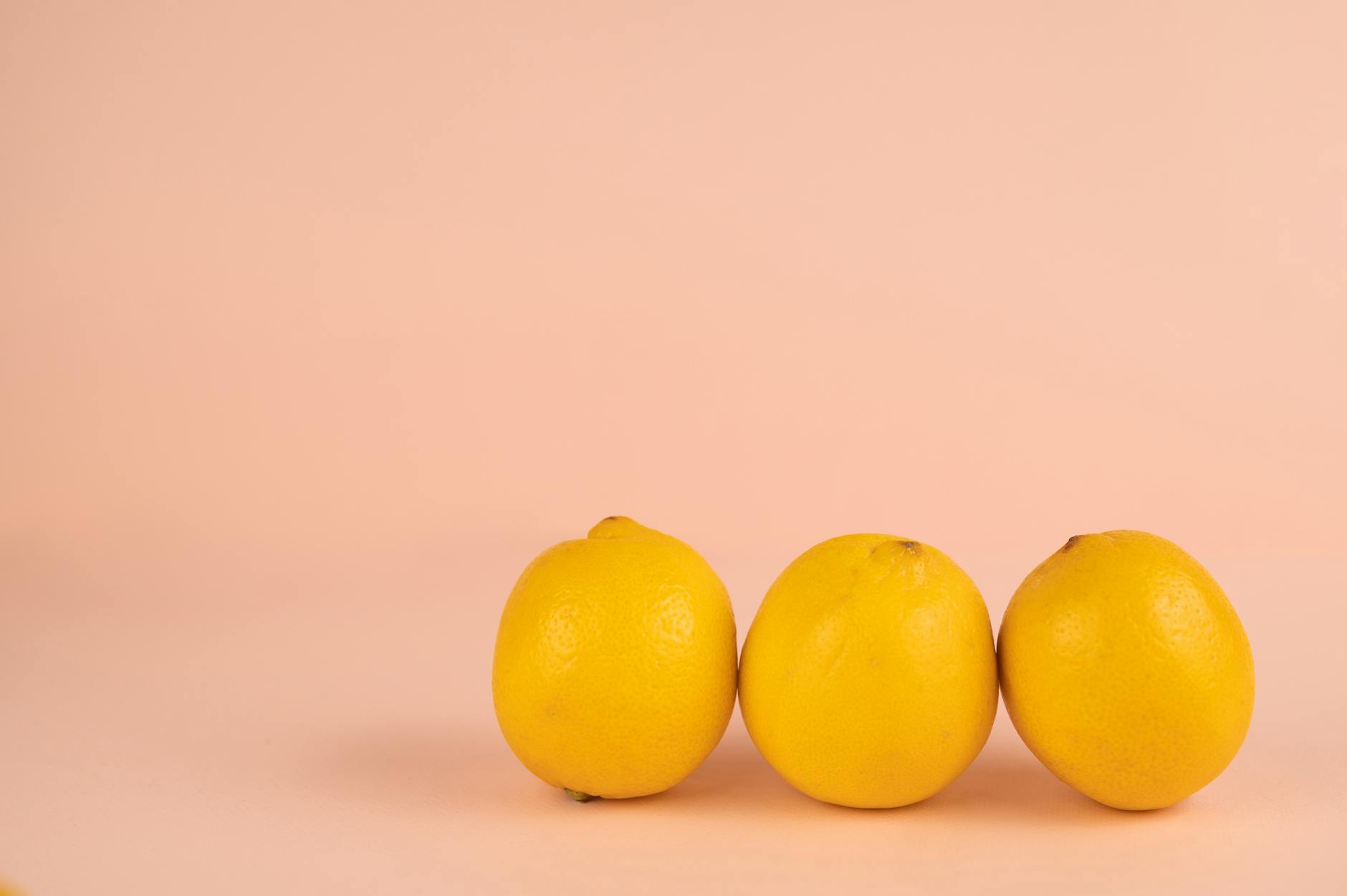 A yellow silicone vibrator surrounded by peeled bananas on a bright yellow background